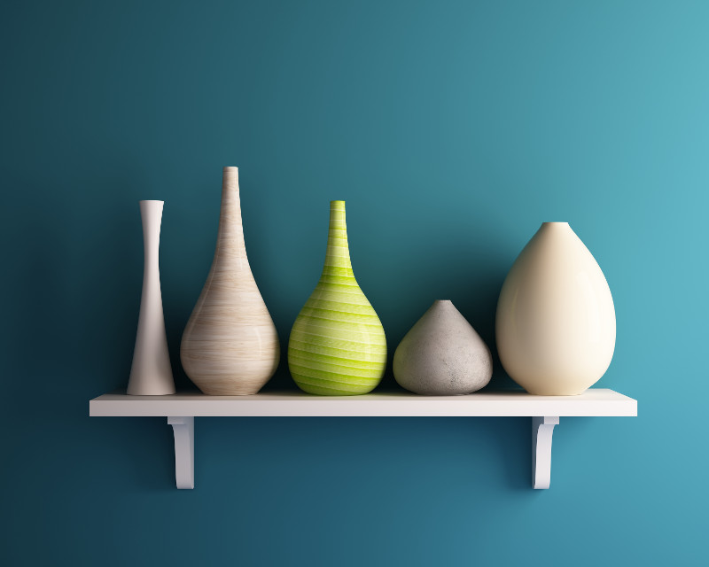 pottery on shelf on brightly painted wall