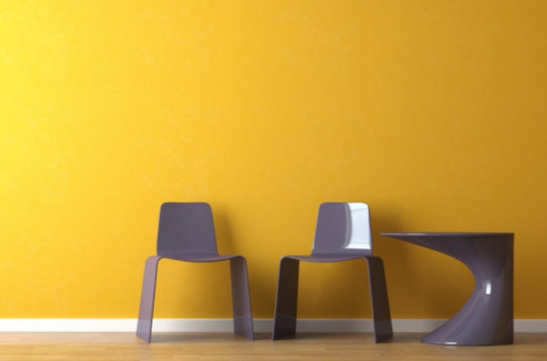 two chairs and a table in front of brightly painted wall