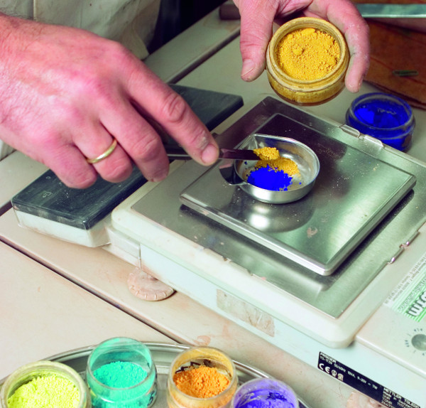 technician working with paint colors in laboratory