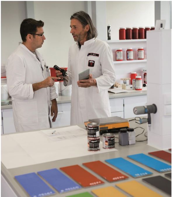 two lab technicians in laboratory with KEIM mineral paint samples